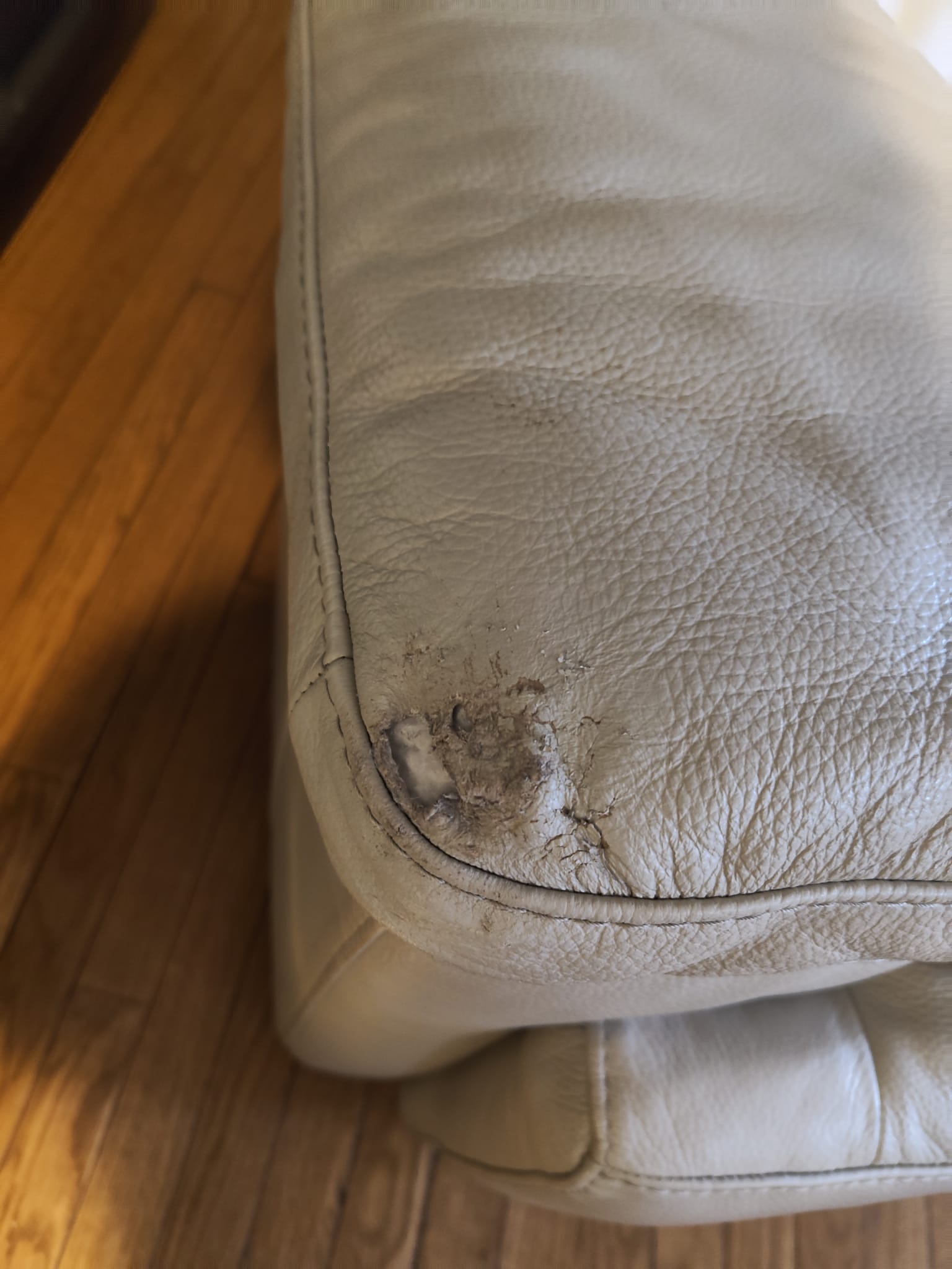 Damaged leather couch before restoration